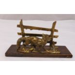 A cast metal letter rack in the form of a fox in front of a fence on rectangular plinth, 9 x 20.5