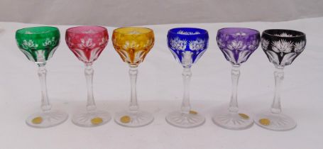 A set of six multi coloured liquor glasses on circular star cut bases