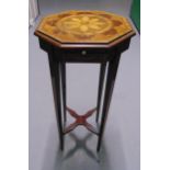 An Edwardian octagonal mahogany plant stand with satinwood inlays on four tapering rectangular legs,