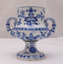 A Meissen onion pattern blue and white baluster vase with two scroll side handles on raised circular