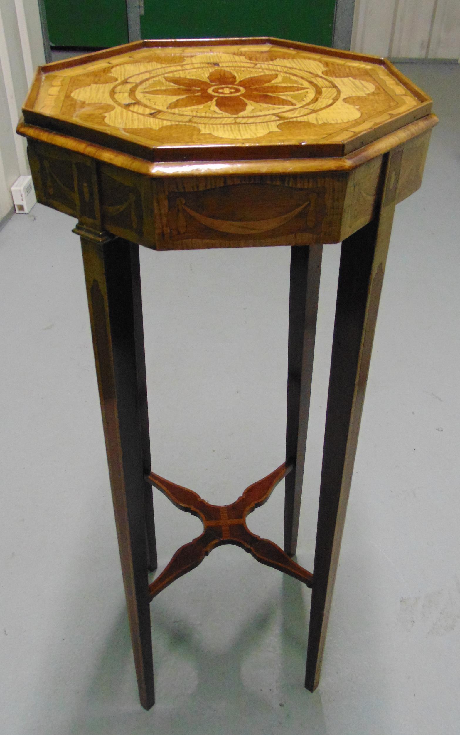 An Edwardian octagonal mahogany plant stand with satinwood inlays on four tapering rectangular legs,