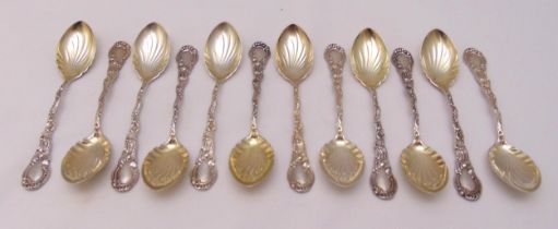 A set of twelve white metal ice cream spoons with scroll chased handles and fluted bowls, stamped