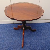 A circular mahogany occasional table on three outswept legs, 50 x 51cm