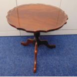 A circular mahogany occasional table on three outswept legs, 50 x 51cm