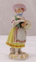 A Meissen figurine of a girl wearing a hat and holding a basket, marks to the base, 13.5cm (h)