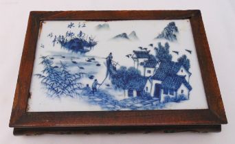 A Republic period rectangular blue and white ceramic plaque depicting figures in a landscape mounted