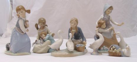 Four Lladro figurines of girls in various poses with ducks, geese, dogs and a cat and two