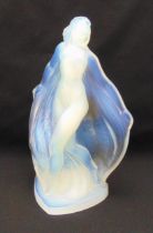 A Sabino Art Deco opalescent glass figurine of a nude lady trailing a floral cloak on a triangular