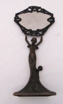 A late 19th century bronze table mirror in the form of a lady with children supporting the oval