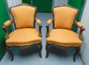 A pair of French style mahogany upholstered armchairs on cabriole legs