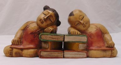 A pair of carved wooden bookends in the form of sleeping children in the oriental style, 20cm (h