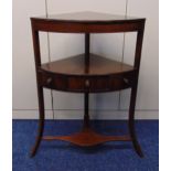 A mahogany corner whatnot with a single drawer with turned brass handles on three outswept legs,