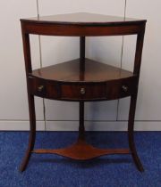 A mahogany corner whatnot with a single drawer with turned brass handles on three outswept legs,