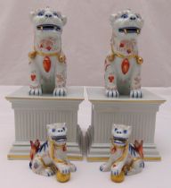 Vista Alegre porcelain figurines of Dogs of Foe, two on fluted square plinths, marks to the base,