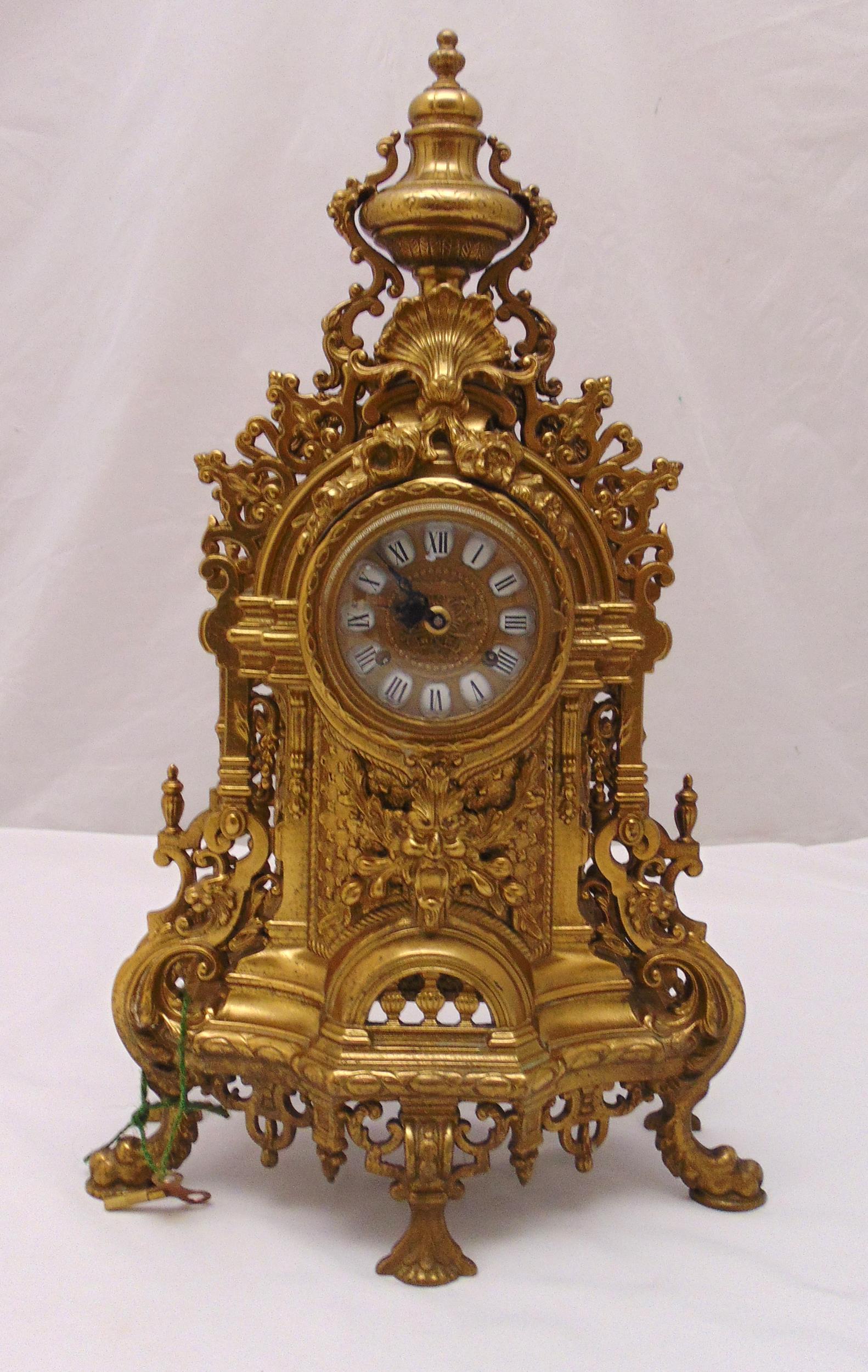 A French late 19th century gilt metal mantle clock, scroll pierced and chased with scrolls and