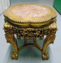 A gilded wooden circular side table with inlaid marble top on four carved legs with claw feet, 46