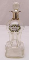 A Regency style decanter with hallmarked silver collar, drop stopper and porcelain wine label,