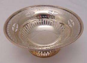 A hallmarked silver circular pierced bonbon dish on raised circular pierced base, Birmingham 1906