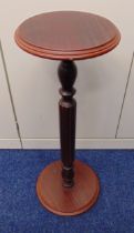 A mahogany circular plant stand on fluted stem and raised circular base, 77 x 26cm