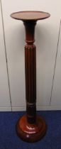 A mahogany torchere plant stand fluted column supporting circular stand on raised circular base, A/