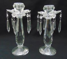 A pair of crystal lustre candlesticks with drop pendants on raised circular bases, 27.5cm (h)