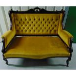 A Victorian upholstered two seater settle on four scroll legs
