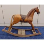 A vintage wooden rocking horse with leather saddle and metal stirrups, 61 x 82 x 27cm