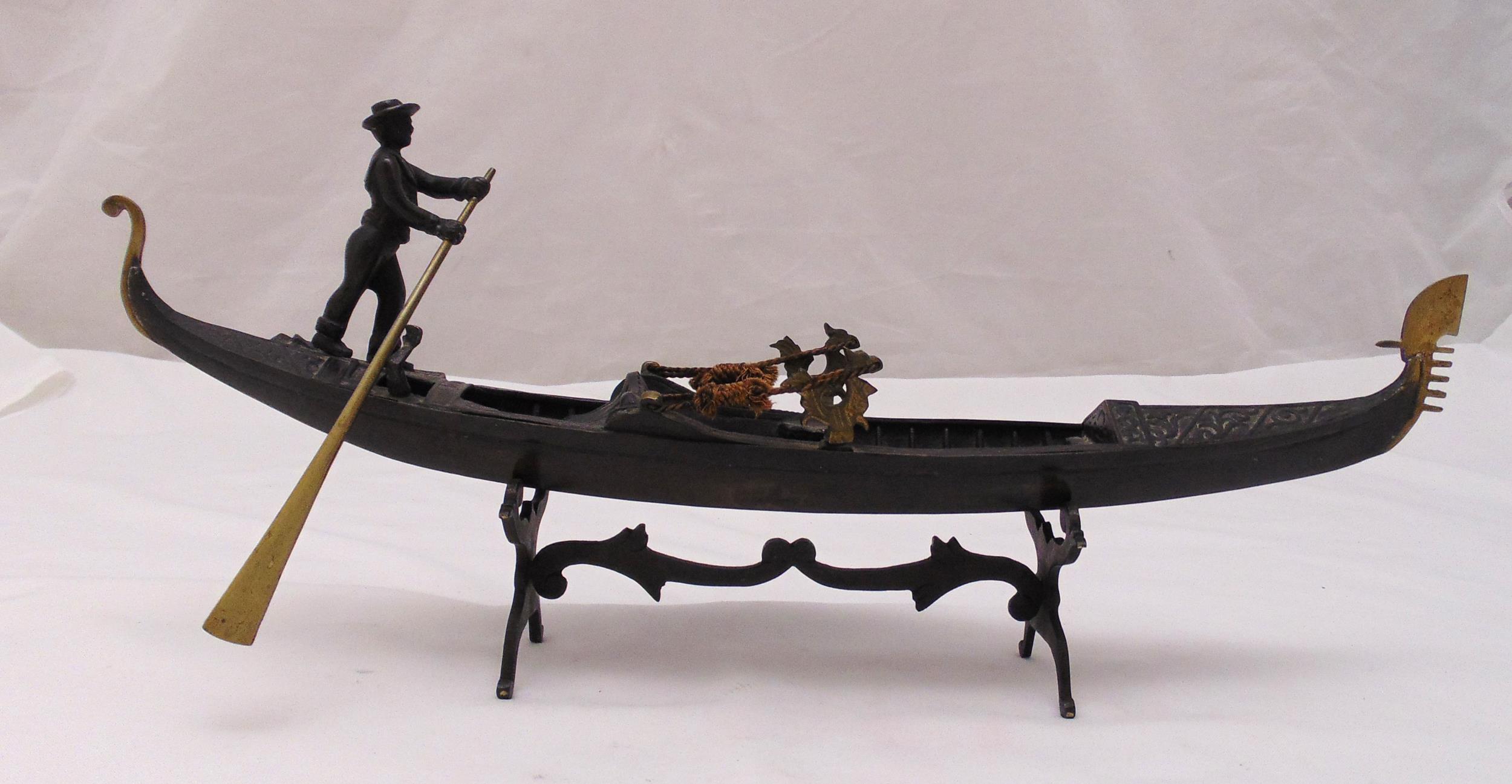 An early 20th century bronze model of a gondola and gondolier, stamped Ricordo Di Venezia, on