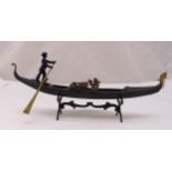 An early 20th century bronze model of a gondola and gondolier, stamped Ricordo Di Venezia, on