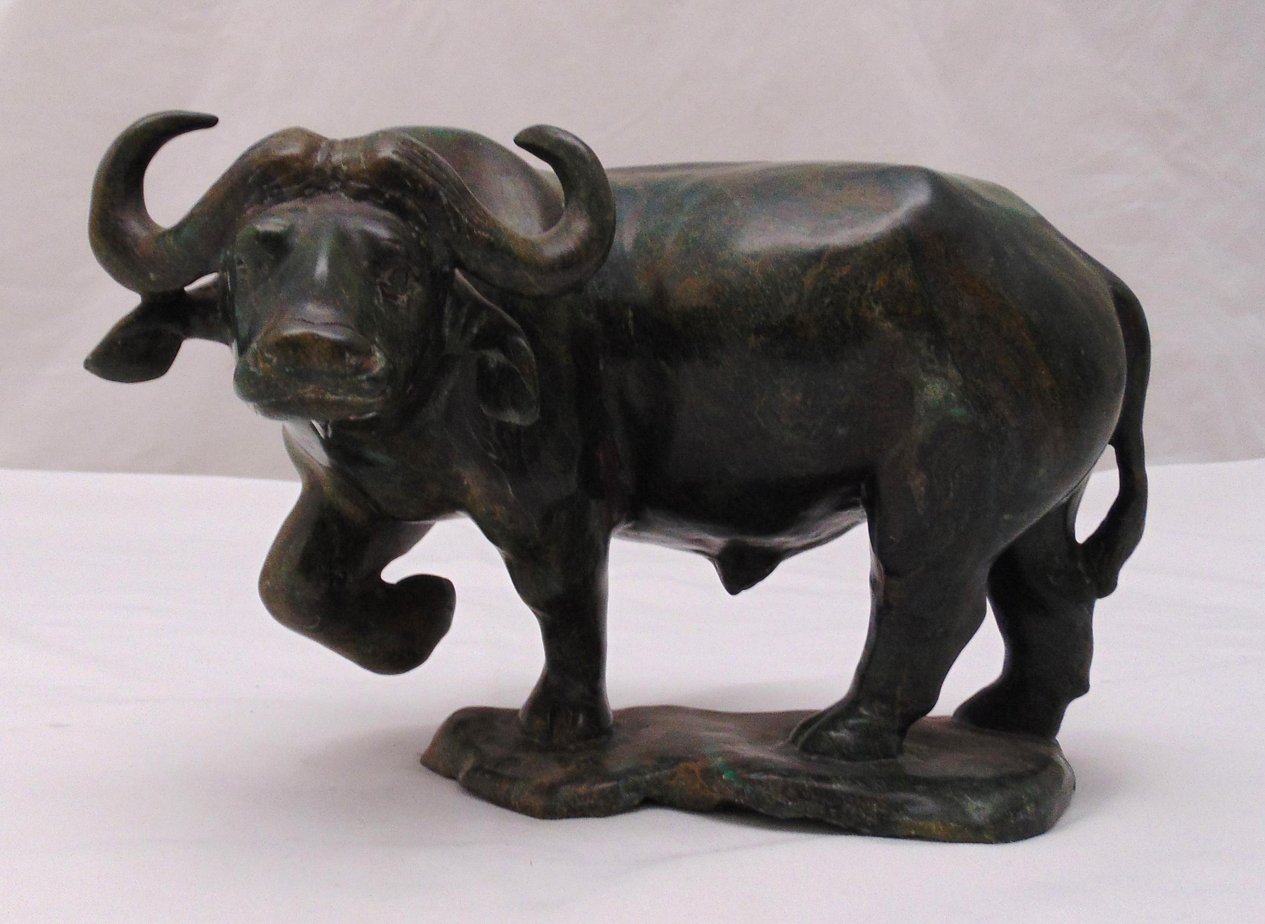 A Nephrite carved figurine of a water buffalo on oval naturalistic base, 20cm (h)