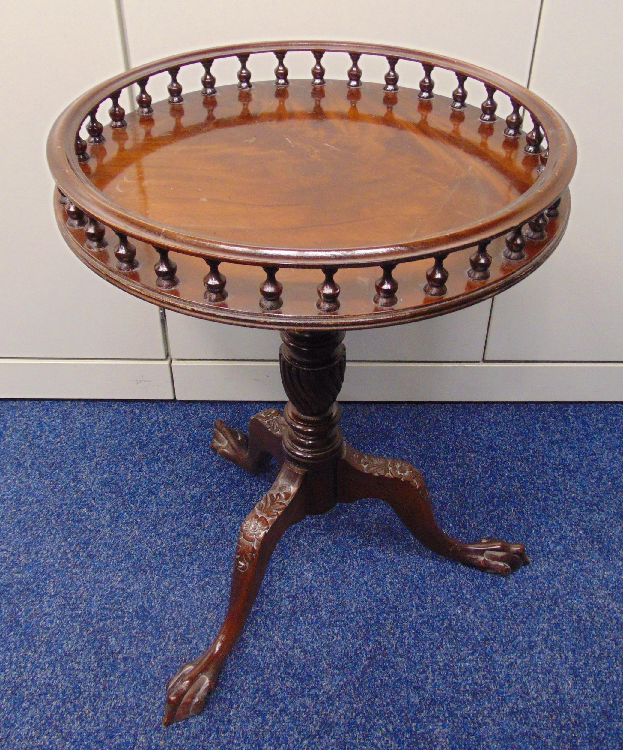 A mahogany circular occasional table with gallery on three outswept legs, 63 x 46cm