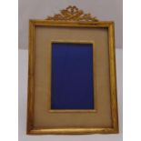 A 19th century French rectangular gilded metal photograph frame with reed and tie border and