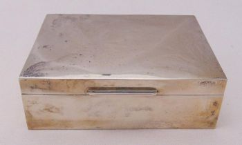 A hallmarked silver rectangular cigarette box, cedar wood lined and hinged cover