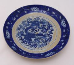 A Chinese Republic period blue and white crackle glazed dish decorated with a dragon chasing a