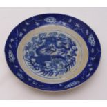 A Chinese Republic period blue and white crackle glazed dish decorated with a dragon chasing a