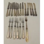 A quantity of hallmarked silver and silver plated butter knives and fruit eaters
