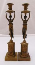 A pair of continental brass candlesticks in the form of classical female figures on cylindrical