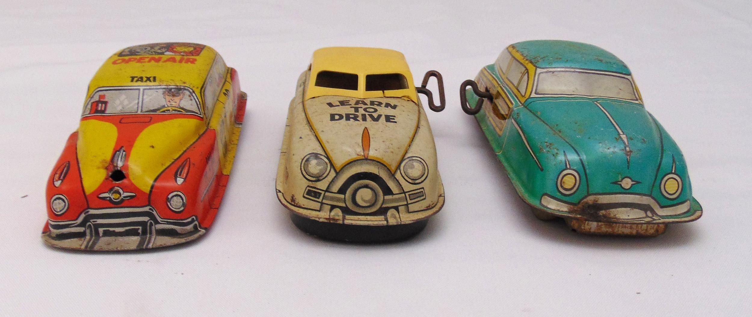 Three vintage litho tin plate toy cars, to include wind up car no 1 learn to drive, friction Taxi no