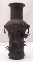 A 19th century Chinese bronze vase with two lion mask side handles and applied dragons to the sides,