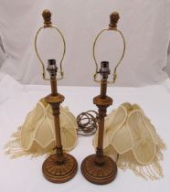 Two brass table lamps of columnular form on raised circular bases with silk shades, 64cm (h)