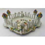 A Dresden shaped rectangular table centre piece, decorated with applied putti and floral sprays,