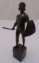 A bronze figurine of a warrior mounted on a black marble rectangular plinth, signed to the base