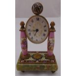 A French desk clock the oval dial with Roman numerals flanked by ovoid columns decorated with