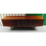 A mid 20th century rectangular teak sideboard with cupboards and drawers on four tapering