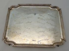 A hallmarked silver shaped rectangular presentation tray on four bracket feet with facsimile