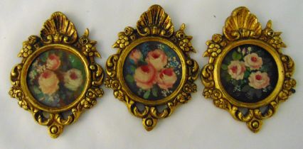 Three gilt metal wall plaques decorated with flowers and leaves, each 11x 8cm