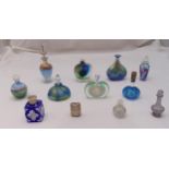 Twelve coloured glass dressing table perfume bottles of various form, size and style