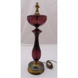 An amethyst glass baluster form table lamp stand on raised circular gilded metal base, 64cm (h)