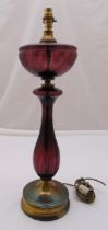 An amethyst glass baluster form table lamp stand on raised circular gilded metal base, 64cm (h)
