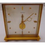 Jaeger LeCoultre rectangular gilt metal mantle clock on four peg feet, 16 x 16.5 x 4cm